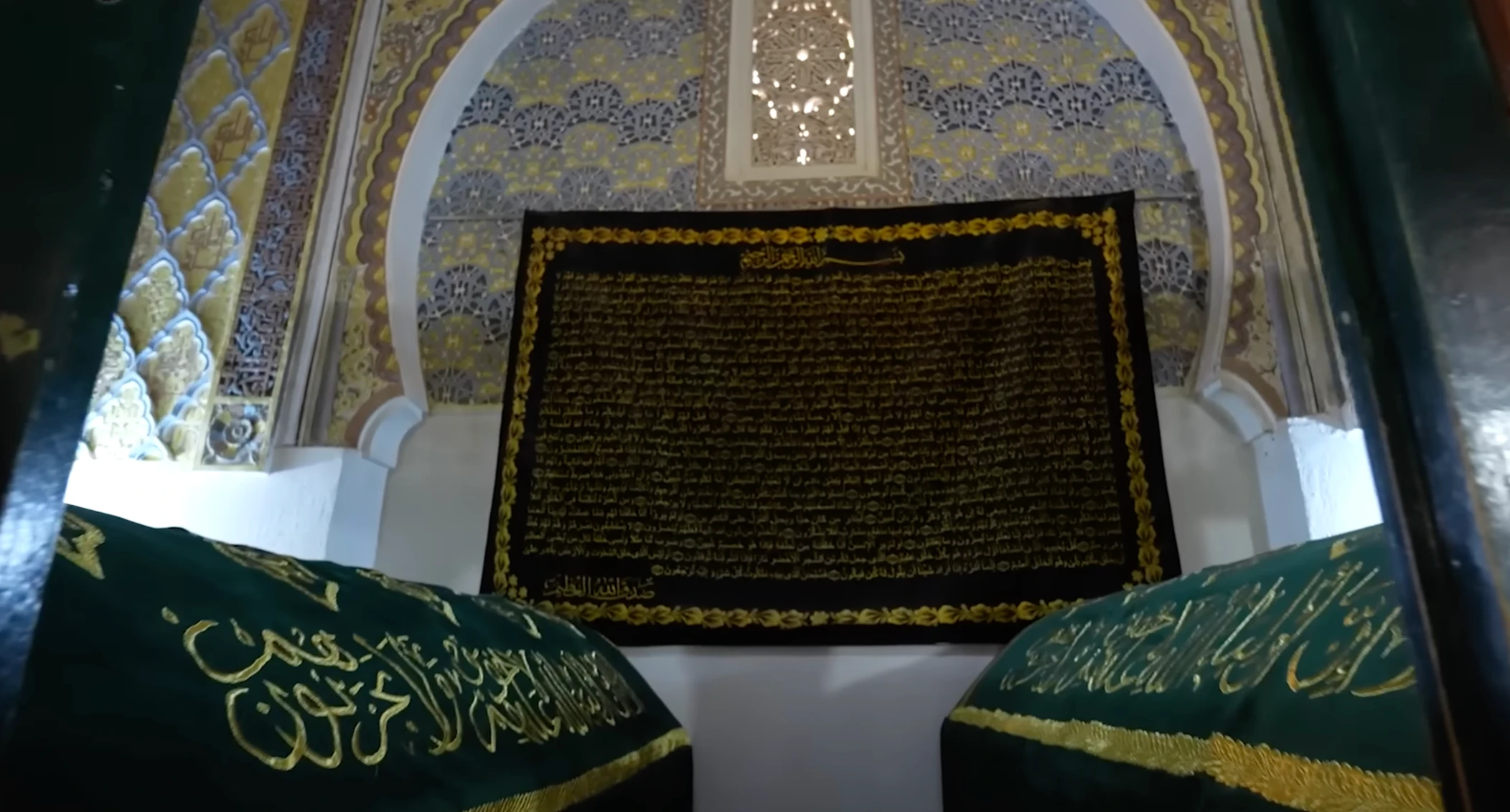 L’intérieur orné du mausolée de Sidi Boumediene à Tlemcen, avec les draperies du tombeau sous une arche de céramique.